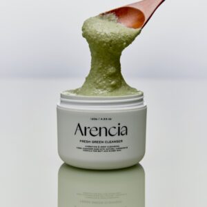 Arencia Fresh Green Rice Mochi Cleanser bottle with green rice grains and natural leaves, showcasing its organic ingredients.